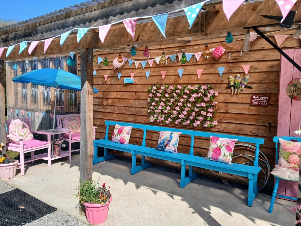 Bunting-draped hen party terrace with blue benches and pink cushions