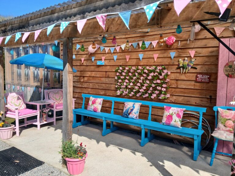 Bunting-draped hen party terrace with blue benches and pink cushions