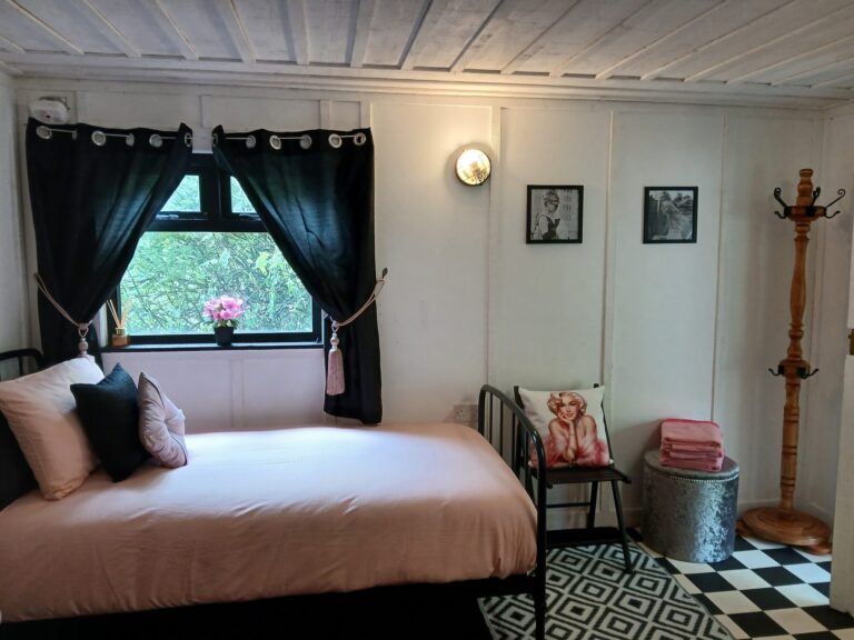 Bright bedroom with daybed and pink cushions