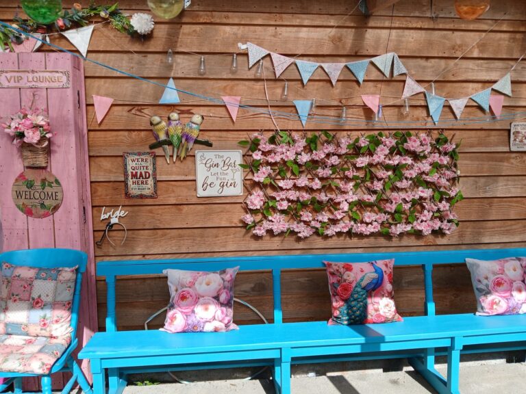 Flower wall and blue benches decorated for a hen party
