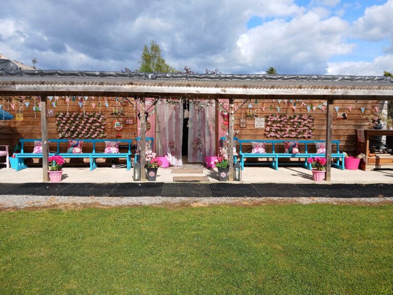 Outdoor terrace with flower wall and lawn on a sunny day
